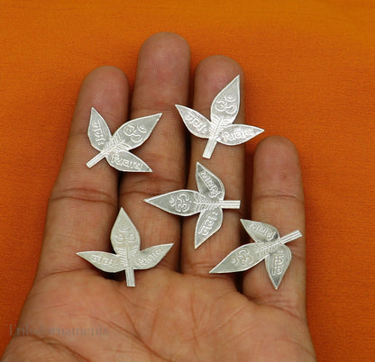 Set of 5 handmade solid silver Belva leaves for Shiva puja, featuring intricate designs and Shiva mantras, by TRIBAL ORNAMENTS.