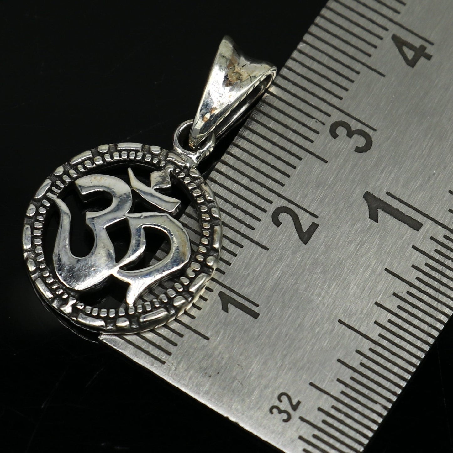 Sterling silver OM 'AUM' pendant from TRIBAL ORNAMENTS, stylish handmade unisex jewelry with personalized design.