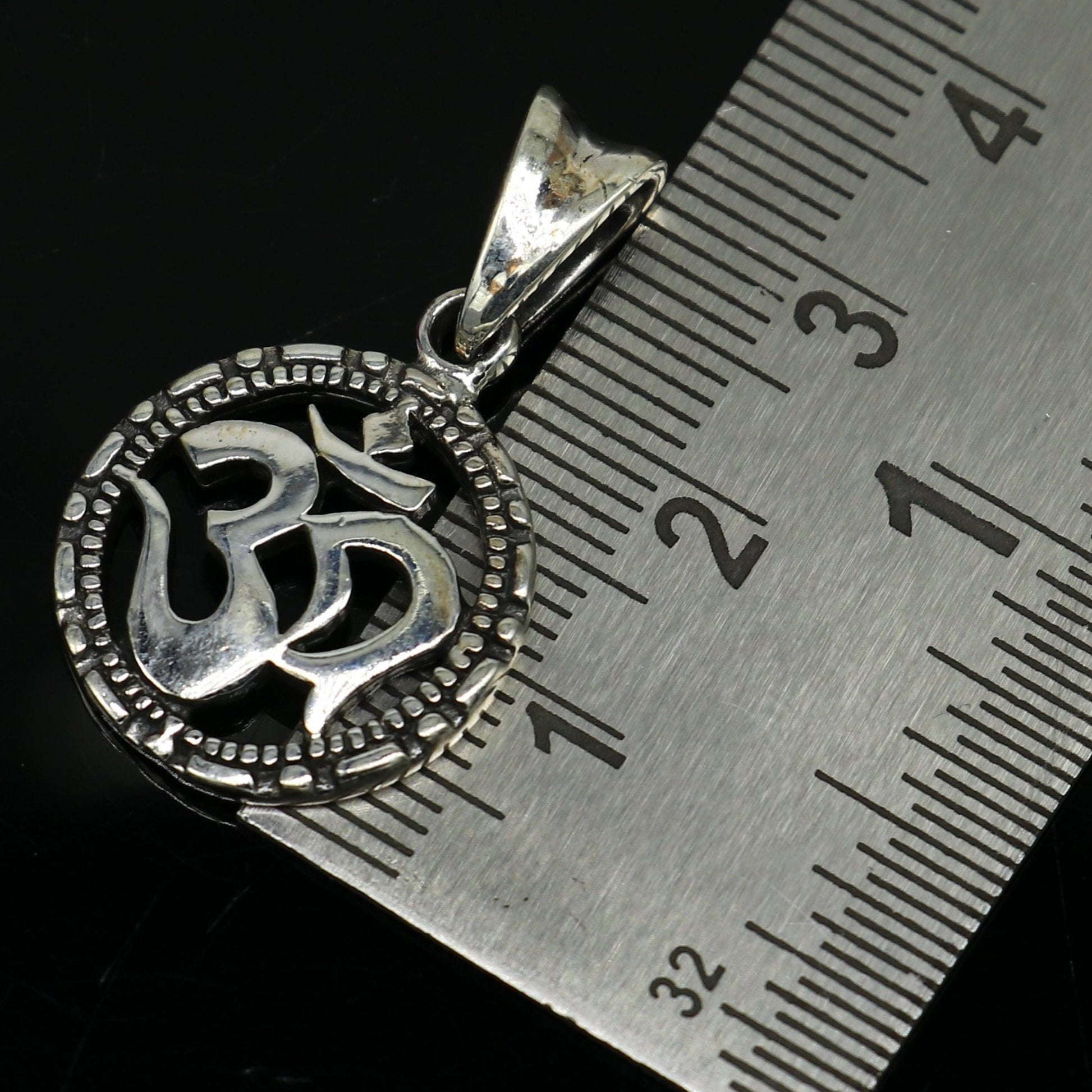 Sterling silver OM 'AUM' pendant from TRIBAL ORNAMENTS, stylish handmade unisex jewelry with personalized design.