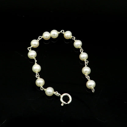 Natural pearl beaded baby bracelet in 925 sterling silver, handmade and customized by Tribal Ornaments for newborn baby jewelry.