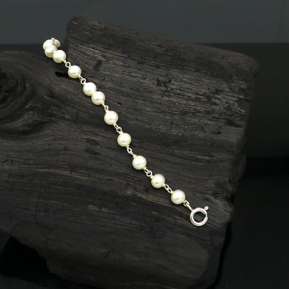 Natural pearl beaded baby bracelet made of 925 sterling silver by Tribal Ornaments, handmade and customizable for newborns.