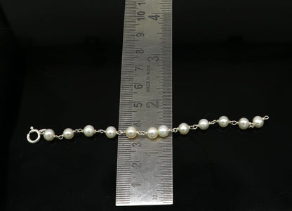 Natural pearl beaded baby bracelet with 925 sterling silver, handmade and customized by TRIBAL ORNAMENTS for newborns.