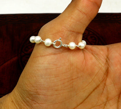 Natural pearl beaded baby bracelet made of 925 sterling silver, handmade and customized for newborn baby jewelry by Tribal Ornaments.