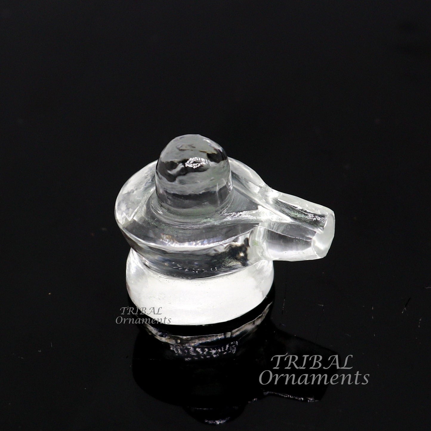 Natural sphatik crystal Shiva Lingam statue from TRIBAL ORNAMENTS, used for wealth and prosperity puja, detailed stone carving.