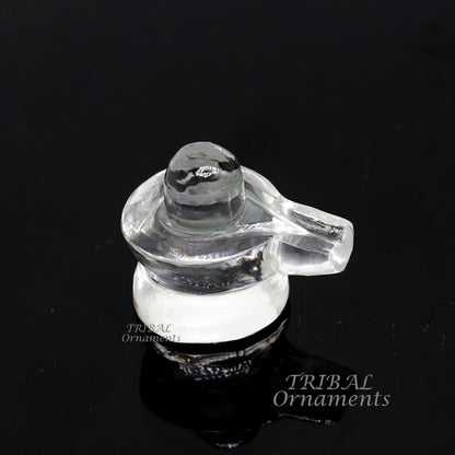 Natural sphatik crystal Shiva Lingam statue from TRIBAL ORNAMENTS, used for wealth and prosperity puja, detailed stone carving.