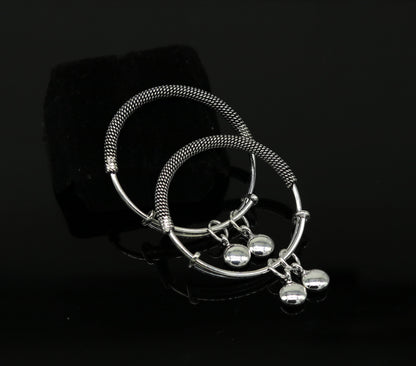 Sterling silver adjustable baby bangle with charms from Tribal Ornaments, featuring oxidized finish and delicate design for newborn kids.