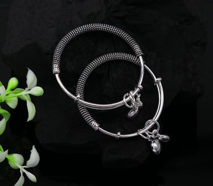 Sterling silver adjustable baby bangle with charm from TRIBAL ORNAMENTS, oxidized finish, suitable for newborns and kids jewelry.