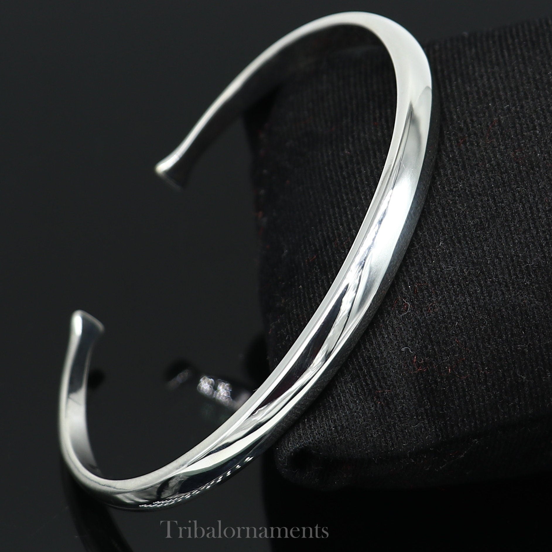 Shiny solid 925 sterling silver adjustable cuff bangle bracelet by Tribal Ornaments, unisex jewelry with a sleek, handmade design.
