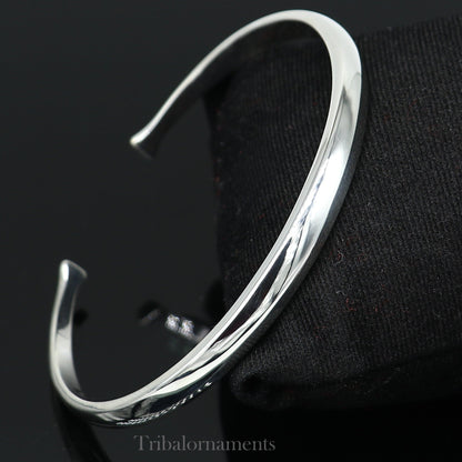 Shiny solid 925 sterling silver adjustable cuff bangle bracelet by Tribal Ornaments, unisex jewelry with a sleek, handmade design.