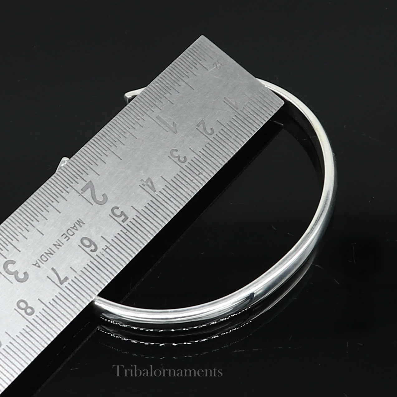 Shiny solid 925 sterling silver adjustable cuff bangle bracelet by Tribal Ornaments, unisex jewelry with a sleek, handmade design.