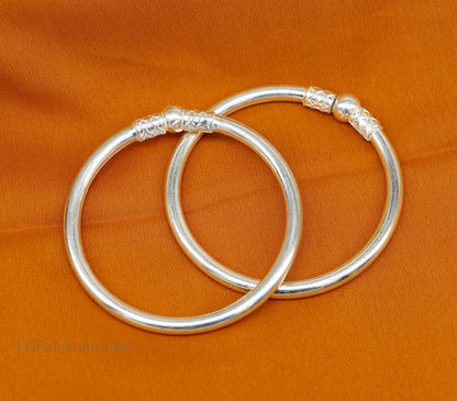 Shiny sterling silver stylish bangle bracelet from TRIBAL ORNAMENTS, Indian designer jewelry, perfect for brides and gifting.