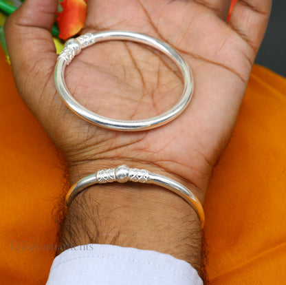 Shiny sterling silver bangle bracelet by TRIBAL ORNAMENTS, stylish designer kada jewelry for brides and gifting purposes.