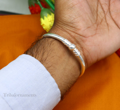 Shiny sterling silver stylish bangle bracelet from TRIBAL ORNAMENTS, featuring a sleek design perfect for gifting or brides.