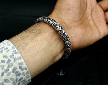 Sterling silver Shiva trident bangle bracelet with detailed Nakshi work, designed for men, from TRIBAL ORNAMENTS India.