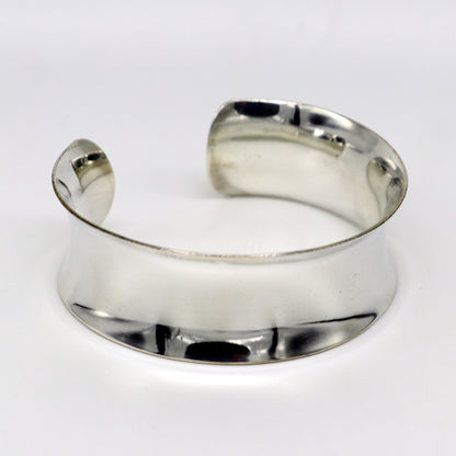 Bright shiny 925 sterling silver cuff bangle bracelet with a trendy curved design from Tribal Ornaments.