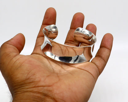 Shiny curved 925 sterling silver cuff bracelet with elegant tribal design, trendy and modern bangle jewelry.