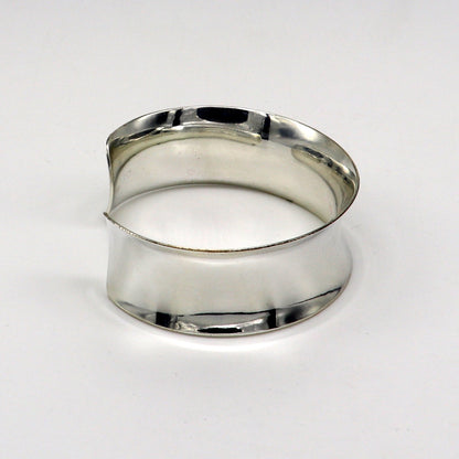 Shiny curved 925 sterling silver cuff bangle bracelet with a trendy, modern design showcasing elegant tribal style.