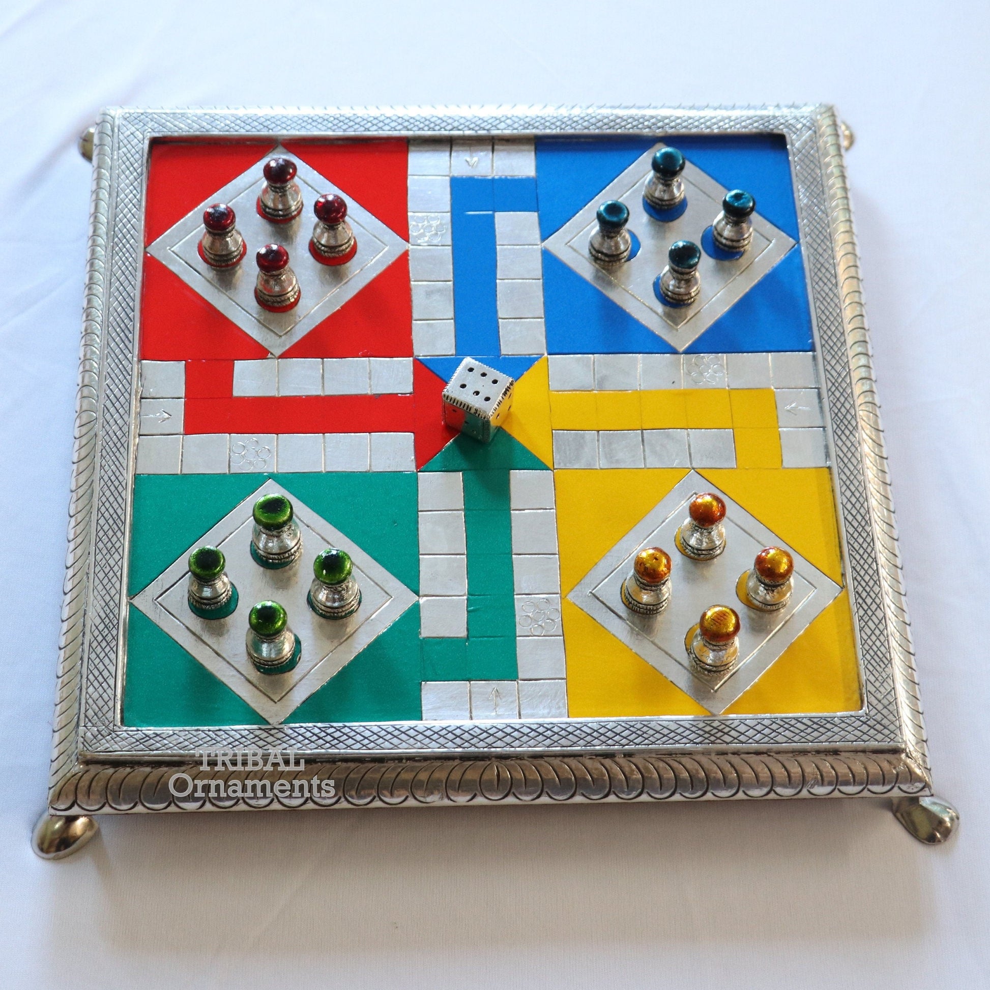 Sterling silver handcrafted LUDO game board on wooden base, featuring intricate tribal design by TRIBAL ORNAMENTS.