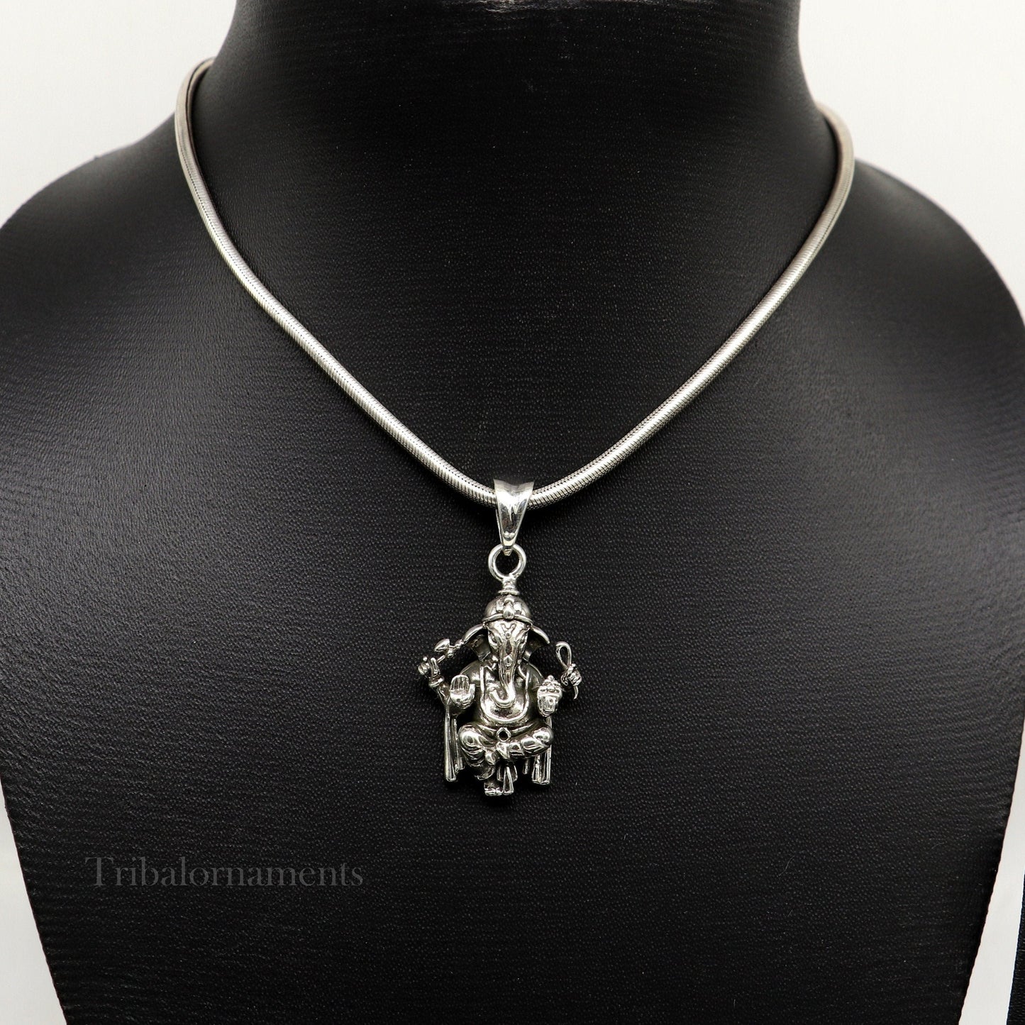 Sterling silver Ganesha pendant by TRIBAL ORNAMENTS, handcrafted unisex jewelry with detailed idol design, customizable gift accessory.