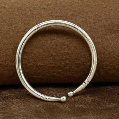 Sterling silver baby bangle by TRIBAL ORNAMENTS featuring a plain shiny design, adjustable baby bracelet for newborns.