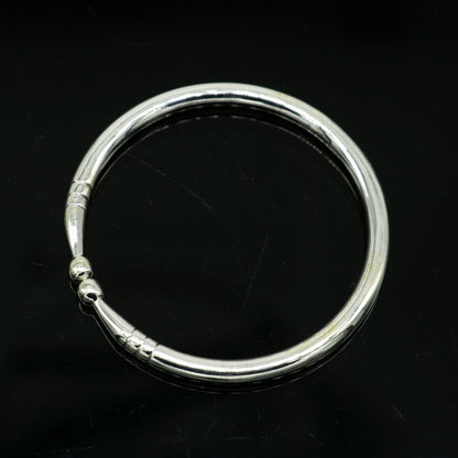Sterling silver newborn baby bangle by Tribal Ornaments featuring a plain shiny design, adjustable baby bracelet or kada.