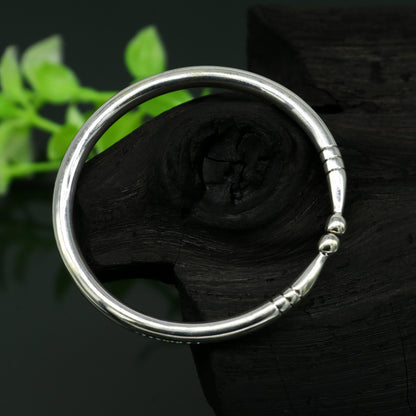 Sterling silver baby bangle bracelet with a shiny, plain design, adjustable and suitable for newborns by TRIBAL ORNAMENTS.