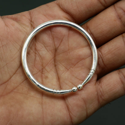 Sterling silver baby bangle by TRIBAL ORNAMENTS featuring a plain shiny design, adjustable baby bracelet for newborns.