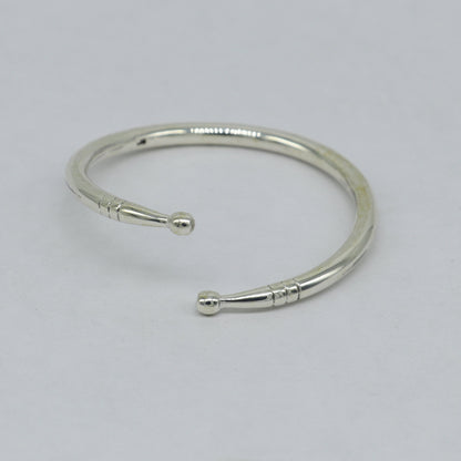 Sterling silver baby bangle from TRIBAL ORNAMENTS featuring a plain shiny design, adjustable baby bracelet for newborns.