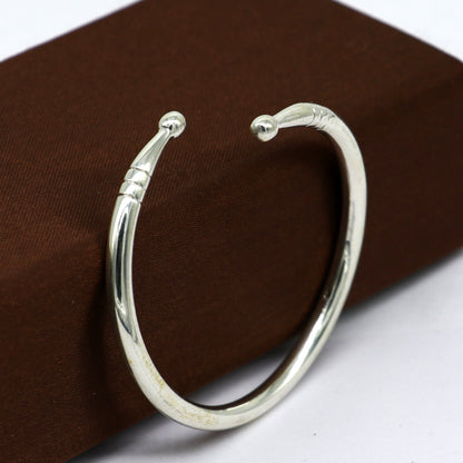 Sterling silver baby bangle bracelet with shiny plain design, adjustable and suitable for newborns, by TRIBAL ORNAMENTS.