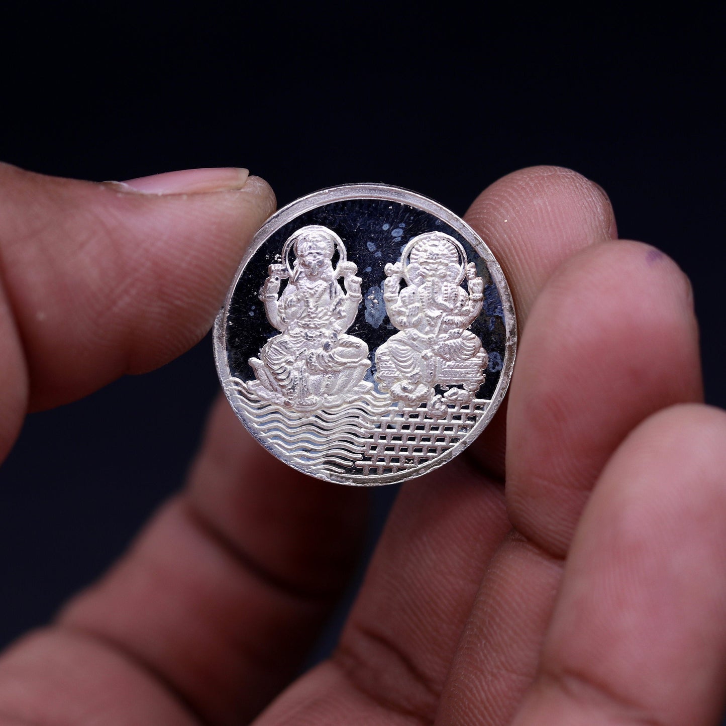 Pure solid 999 silver Indian idol coin featuring Lord Ganesha and Laxmi print, 5 grams, collectible and ideal for gifting.