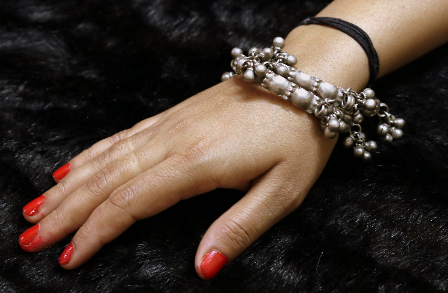 Vintage Rajasthan silver bangle bracelet for women with tiny bells and intricate ethnic tribal design.