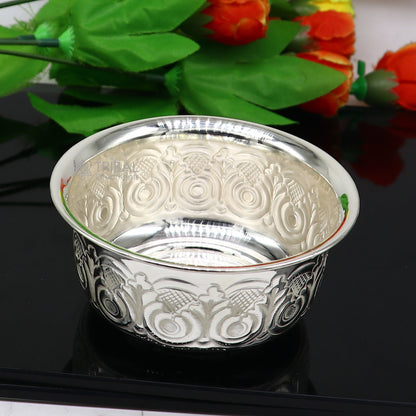 Silver handmade work bowl and utensils for rice ceremony and puja, featuring intricate tribal design and craftsmanship.