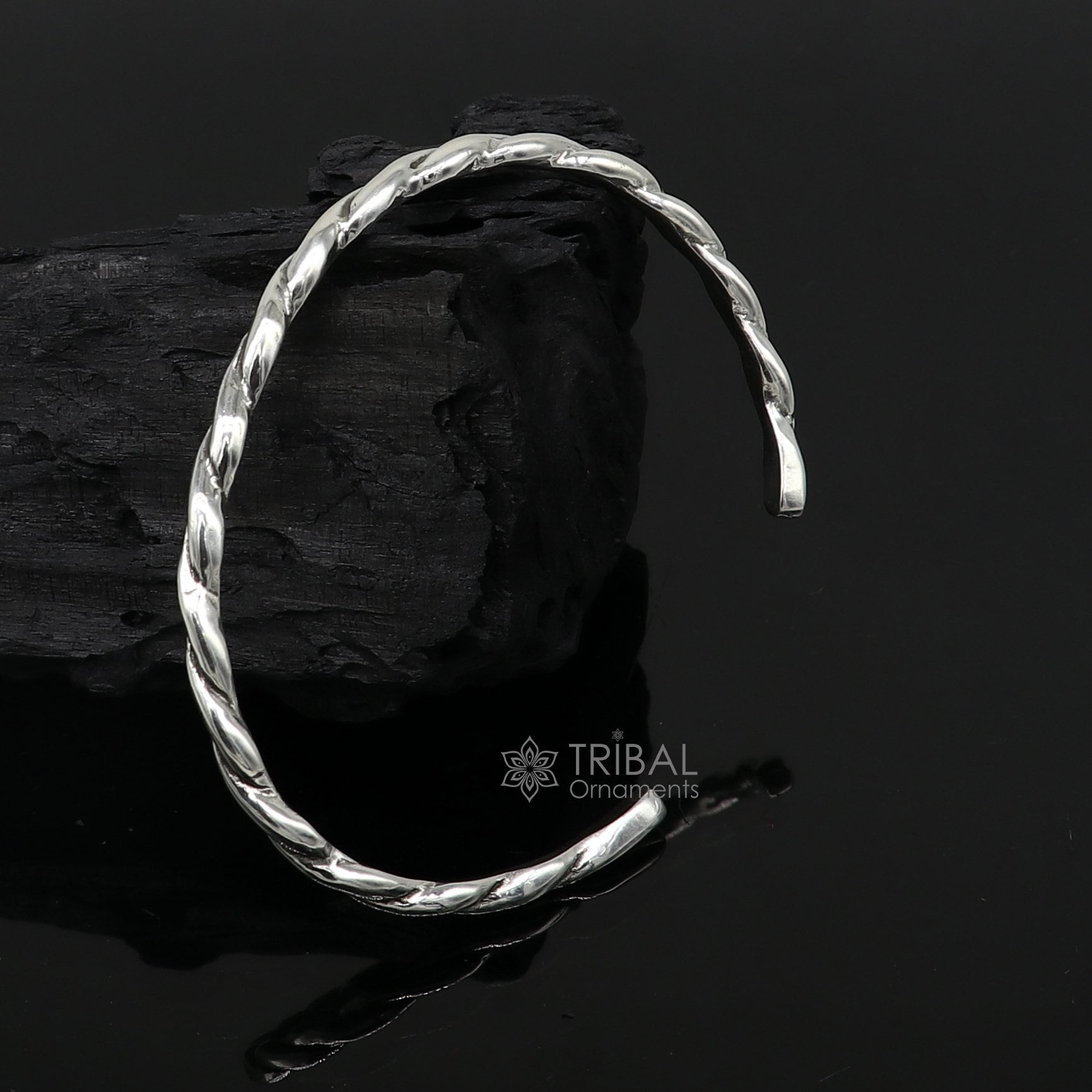 Sterling silver twisting cuff bracelet by Tribal Ornaments, modern unisex design, 4mm wide, stylish bangle for gifting or everyday wear.
