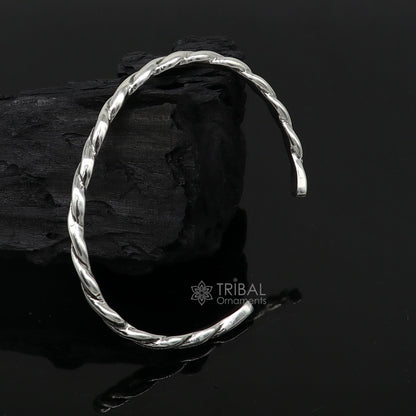 Sterling silver twisting cuff bracelet by Tribal Ornaments, modern unisex design, 4mm wide, stylish bangle for gifting or everyday wear.