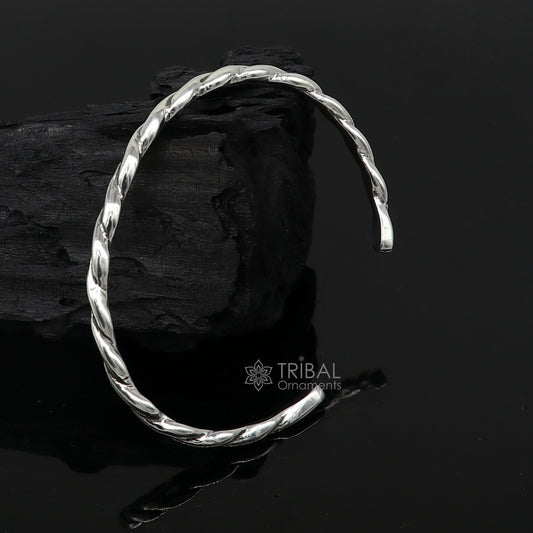Sterling silver twisting cuff bracelet by Tribal Ornaments, modern unisex design, 4mm wide, stylish bangle for gifting or everyday wear.