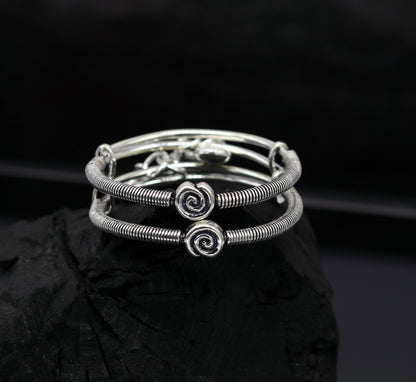 Sterling silver baby adjustable bangle bracelet with stylish designer charm, handmade by TRIBAL ORNAMENTS.