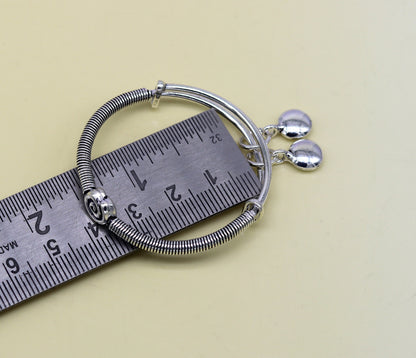 Sterling silver handmade baby adjustable bangle bracelet with stylish designer charm, crafted by TRIBAL ORNAMENTS.