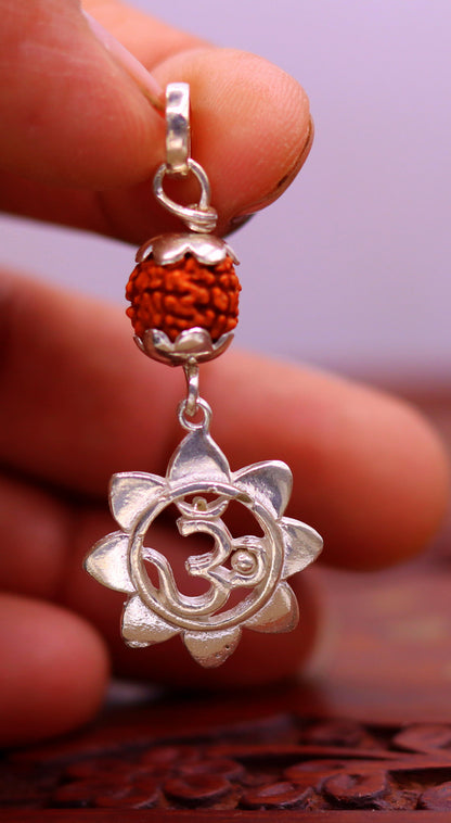 Sterling silver Aum pendant with natural rudraksha bead, unisex tribal jewelry, handmade and stylish for modern spiritual wear.