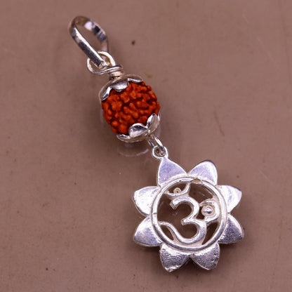Solid sterling silver Aum pendant with a natural rudraksha bead, unisex tribal jewelry, handmade and stylish for modern wear.
