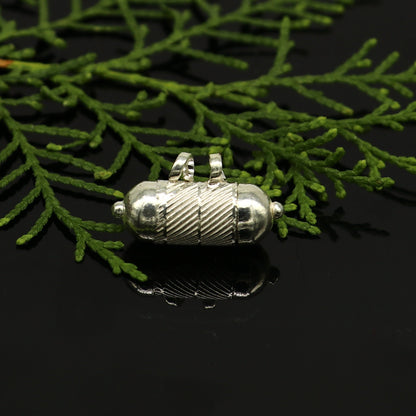 Solid sterling silver round amulet box pendant with tribal design, featuring engraved mantra and kavacham motifs.