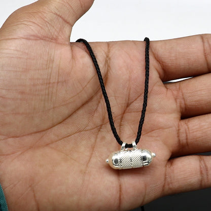 Solid sterling silver round amulet box pendant with tribal design, featuring engraved mantra and tabiz elements.