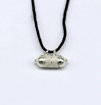 Solid sterling silver round amulet box pendant with tribal design, featuring engraved mantras and vintage style tribal jewelry.