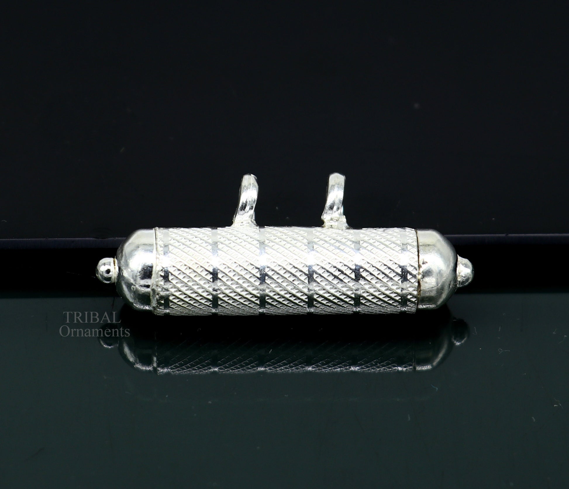 Solid sterling silver round amulet box pendant with handcrafted tribal design, featuring mantra and mascot motifs.