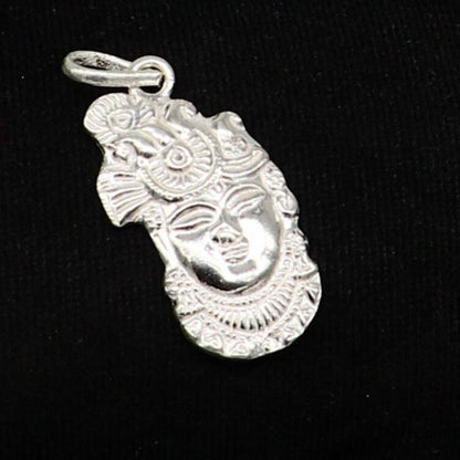 Solid sterling silver Lord Krishna Shreenathji tiny pendant, handmade unisex jewelry by TRIBAL ORNAMENTS, detailed Hindu deity design.