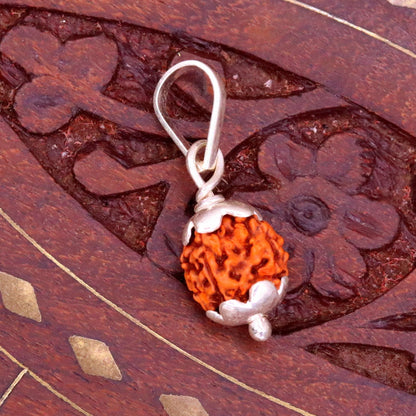 Solid sterling silver Rudraksha pendant from TRIBAL ORNAMENTS, handmade unisex jewelry with detailed Rudraksha bead design.