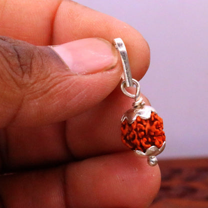 Solid sterling silver Rudraksha pendant from TRIBAL ORNAMENTS, featuring intricate handmade design and lightweight unisex jewelry.