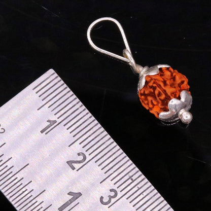Solid sterling silver Rudraksha pendant from TRIBAL ORNAMENTS, showcasing detailed handmade design and lightweight unisex jewelry.
