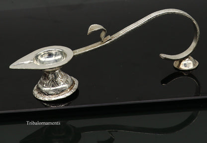 Solid sterling silver handmade vintage Aarti lamp for home temple decor, featuring intricate design and classic temple accessories.