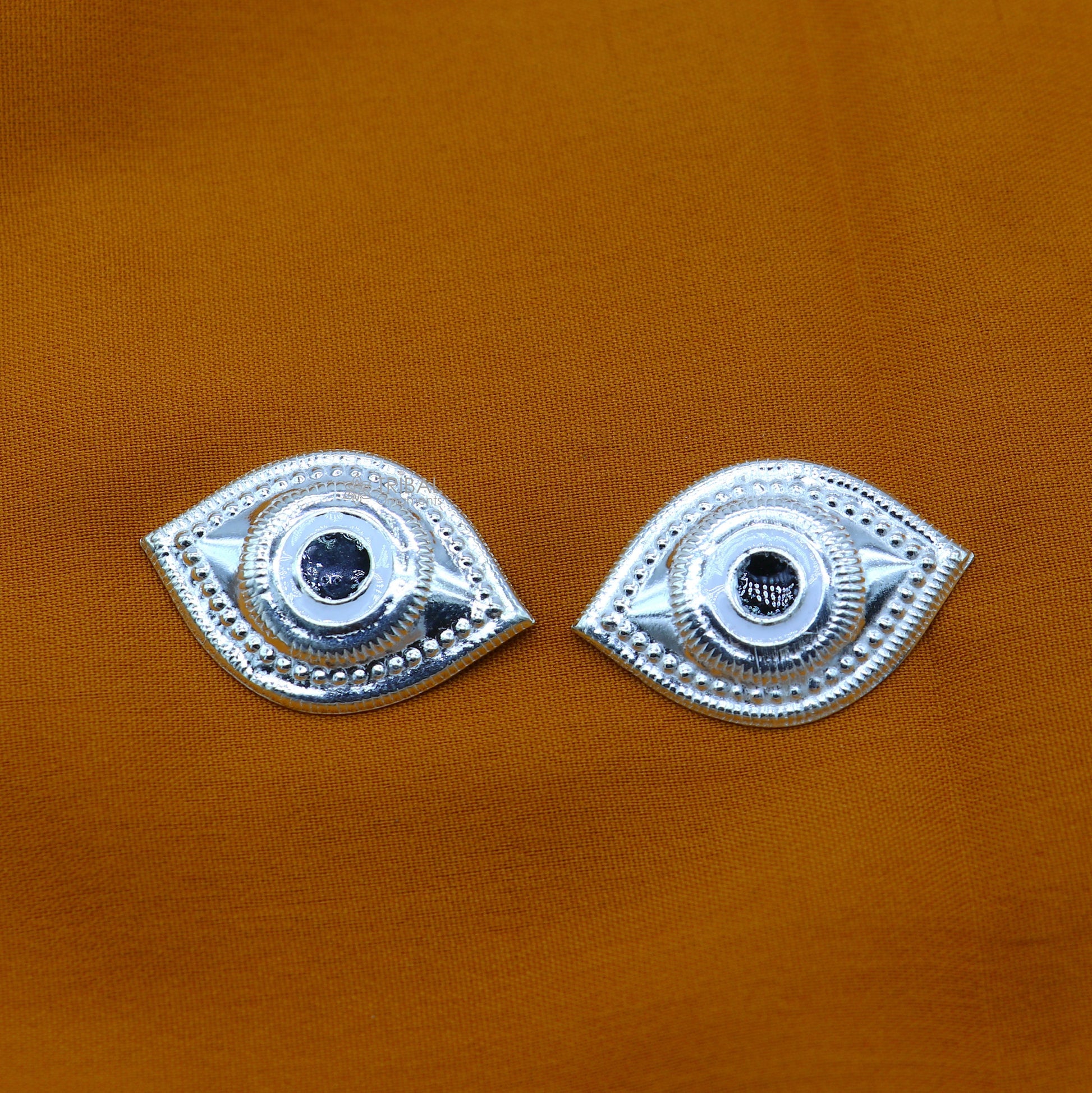Solid sterling silver Netra eyes for Lord Jagannath and Laddu Gopala idols, featuring intricate white craftsmanship by TRIBAL ORNAMENTS.