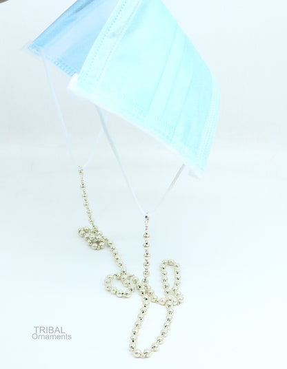 Sterling silver face mask chain and eyeglass necklace by TRIBAL ORNAMENTS, stylish women’s sunglass and eyeglass cord with decorative details.